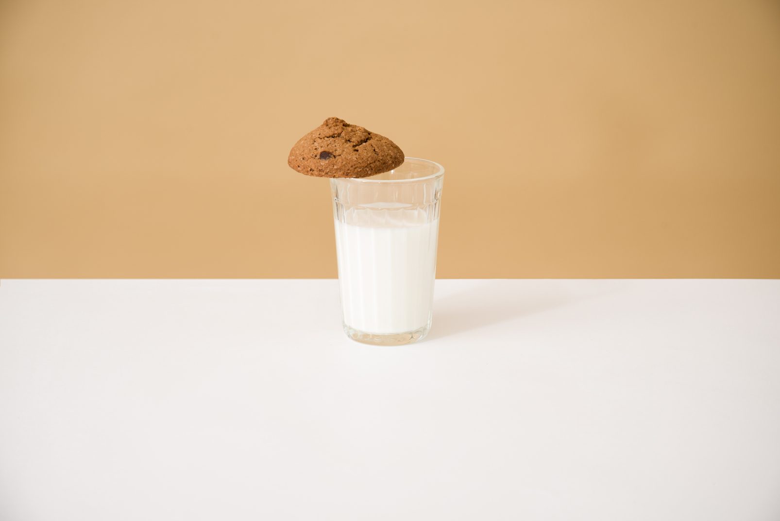 World milk day 2021: there is a glass of milk on the table, there are cookies on the glass