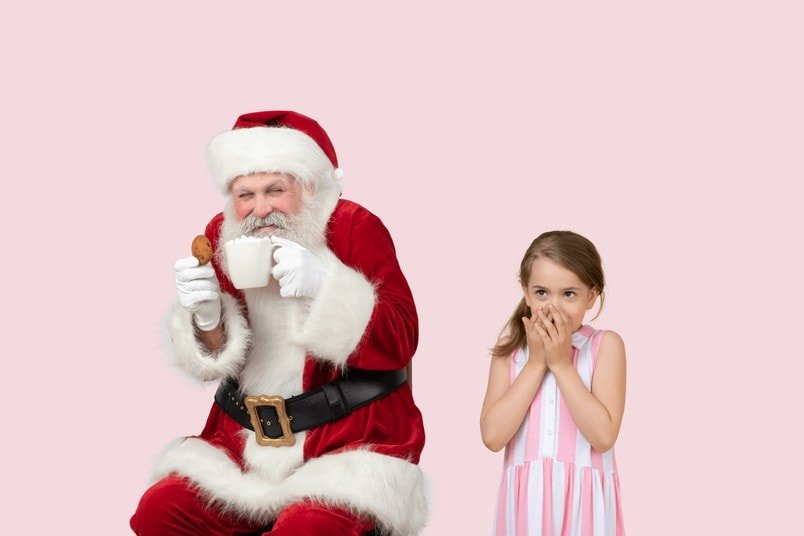 Santa with cookies and a cute girl